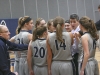 Rachel Slaney joins her Madison College teammates in a huddle during a timeout.