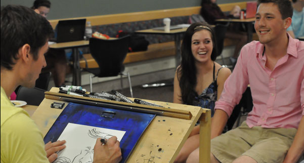 Illustrator Theo Howard is shown giving free 5-minute caricatures to students looking to get their goofy on.
