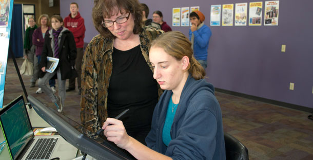 Karen Johnson works with Graphic Design student Jamie Larsen on creating an animation using a Wacom Interactive Pen Display tablet on Nov. 8.
