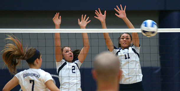 WolfPack Volleyball players block a shot