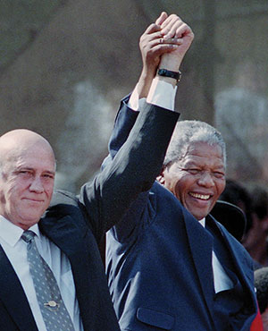 South African president Nelson Mandela, right, holds hands with former South African president F.W. de Klerk in Cape Town, South Africa, in a 1994 file image. Mandela died on Thursday, Dec. 5.