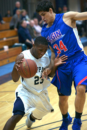 WolfPack men’s basketball player Jeffrey Cole (23) fights his way past an Elgin player during the team’s 75-68 victory at home on Dec. 3. The win was the second for the Madison College men’s basketball team this season.