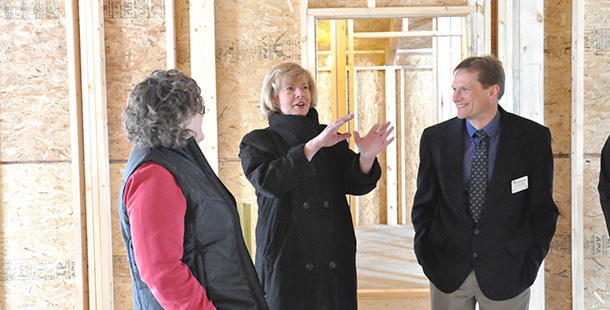 U.S. Sen. Tammy Baldwin visits with two Madison College instructors during her stop at the college’s Commercial Avenue campus on Friday, Jan. 31.