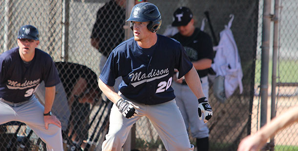 Madison College baseball player Marcellus Sneed leads off third base as coach Mike Davenport looks on.