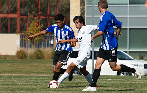Madison College men’s soccer player Harley Schultz battles two Dakota County Technical College players for the ball during the Oct. 11 game at home. The WolfPack lost, 2-0.