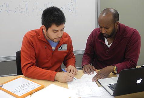 Oscar Longoria, left, tutors AbdiFatah Abdishaikh in math.