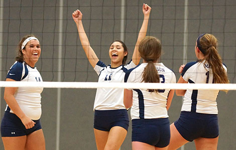 The Madison College volleyball team celebrates a win over Edgewood JV on Oct. 23.