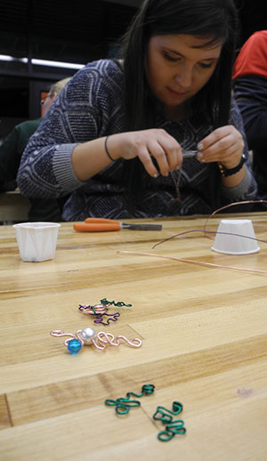 Arts Editor Marisa Comeau-Kerege learns how to make jewelry out of wire at Memorial Union’s monthly Free Art Fridays.