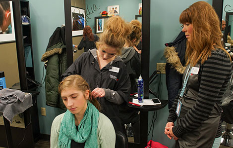 Amy Johnson gets her hair braided at the Trustyle Salon.