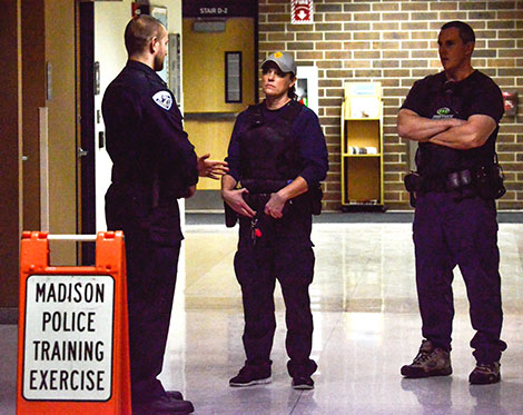 Officers visit outside the WolfPack Den during a training exercise held at the Madison College Truax Campus on Jan. 12