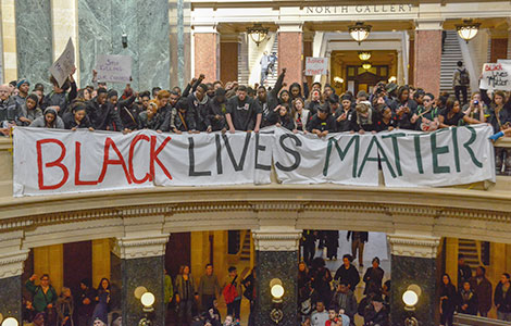 Students protesting at the State Capitol rotunda in Madison earlier this month hold a banner proclaiming, “Black Lives Matter.”