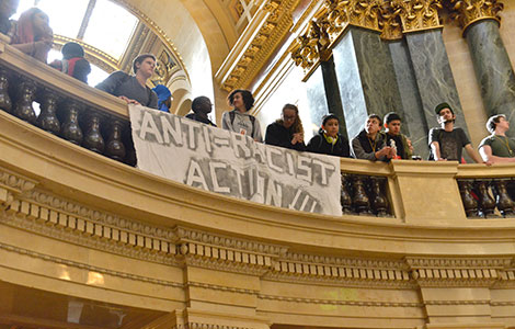 Students hold a banner in the State Capitol rotunda during a protest earlier this month.