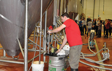 Joe Waltz checks quality control at Ale Ayslum. He also teaches the practicum brewing courses for Madison College.