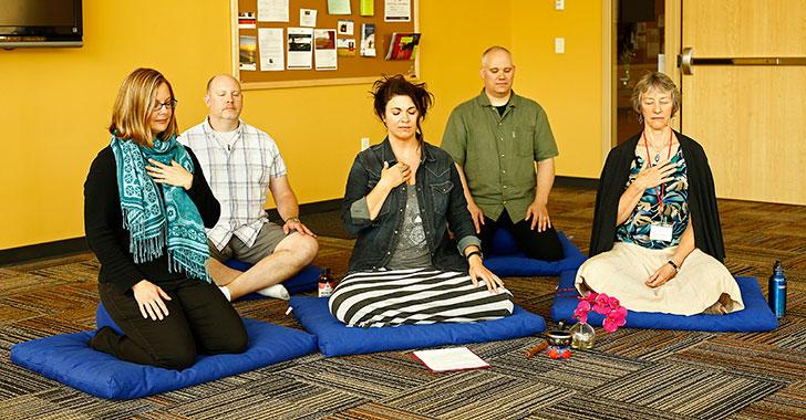 Therapeutic massage instructor Amy Nicholson, center, leads a Mindful Meditation group during a 30-minute session at the Health Education Building.
