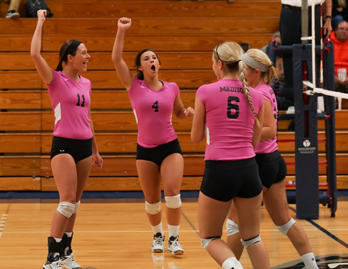 Madison Colleges volleyball team celebrates during a recent match.