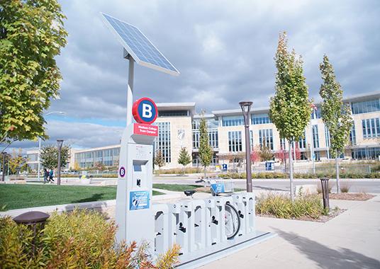 The BCycle station is located outside the Health Education and Information Thechnology Building, across the street from the Truax Gateway.