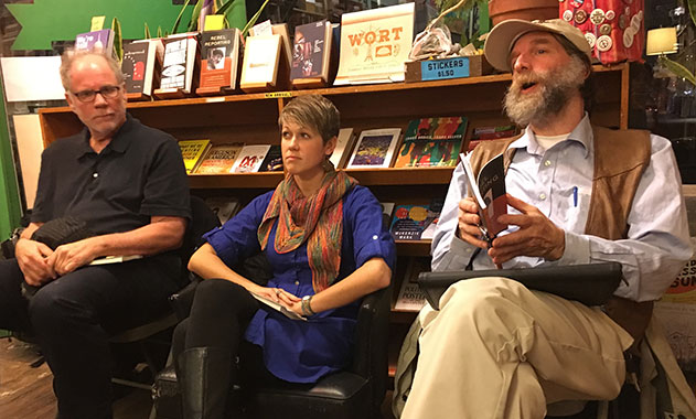 Cristalyne Bell (center), sits with co-editor Norman Stockwell (right), and Robert W. McChesney, who wrote the foreward to “Rebel Reporting” during the book launch inside The Rainbow Bookstore Cooperative on Dec. 15 in Madison.