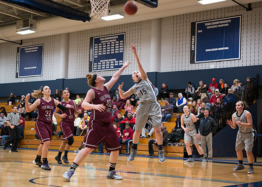 Kaitlyn Kast (15) leaps for the ball during WolfPack 96-37 win against the Fox Valley Technical College Foxes on Jan. 4.