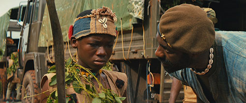 Agu (left, Abraham Attah) and Commandant (right Idris Elba, in the Netflix original film, “Beasts of No Nation.”