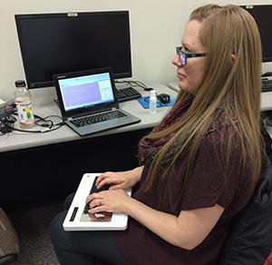 Jessica Bolanos, a fifth semester student in the court reporter program, demonstrates how the stenograph machine is used.