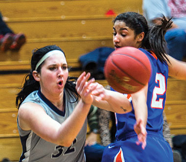 Madison College women’s basketball player Megan Petty passes the ball around a Milwaukee Area Technical College defender during a recent home game.