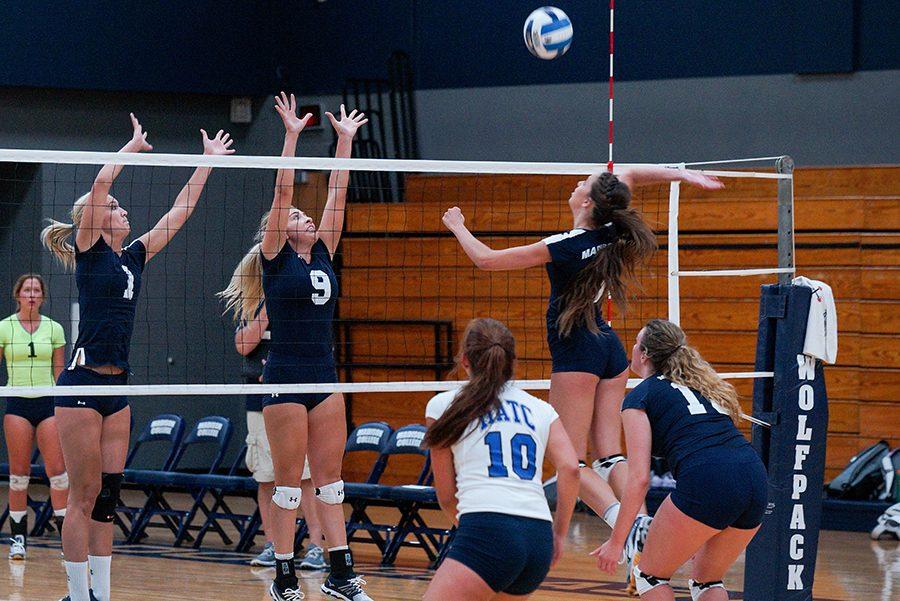 Sophomores Andrea Bauer (right) and Taylor Genthe block during the WolfPack Almuni game on Aug. 12.