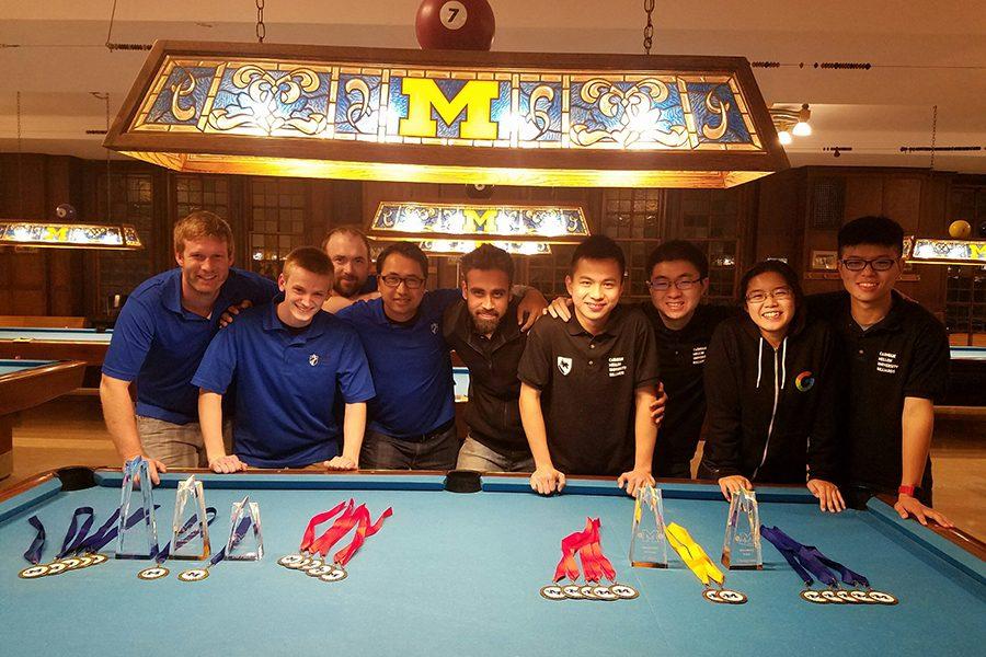 Members of the Madison College Pool club, left, pose for a group photograph with the Carnegie Mellon team on Nov. 13 after winning the University of Michigan’s annual Team Pool Championship. Carnegie Mellon finished second. Madison College team members include Eric Bumgarner, Touy Bouapha, Ian Robertson and Jason Matzke.