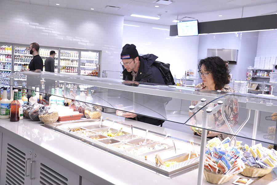 Guests review the options available at the Madison College Atrium Cafe on the Truax Campus. The newly completed cafeteria opened with the start of the spring semester.