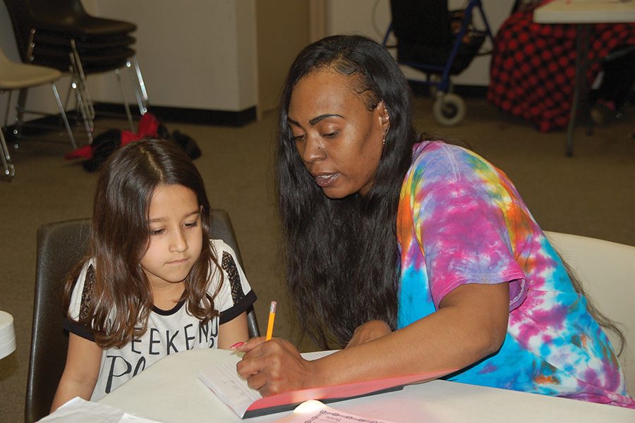 China Miller helps a student at the after school Level Up Homework Club.