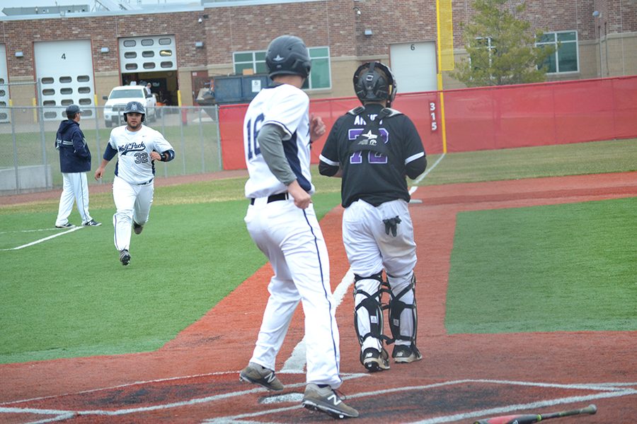 Madison College’s Chase Scharnek (16) scores and encourages Carson Carmody (32) to follow him home during his team’s victory over Prairie State College on April 2 at Sun Prairie High School.