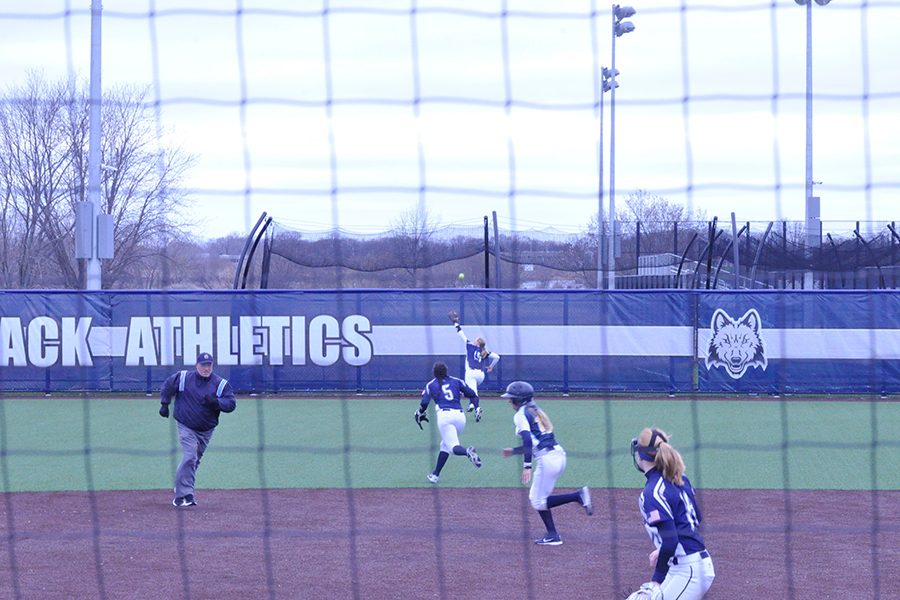 Madison College softball players react to a triple to right field hit by Rock Valley College’s Madason Shaw on April 14.