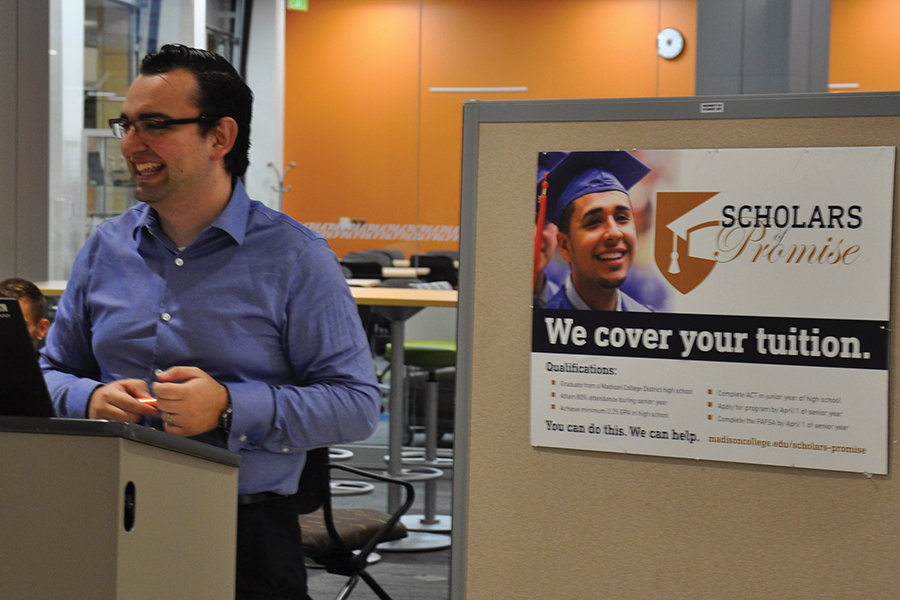 Javier Neira Salazar, director of the Madison College Scholars of Promise Program, checks in students at a back-to-school event at the Truax Campus in mid-August.