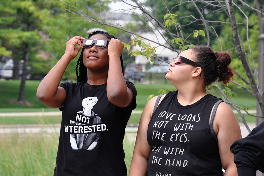 Students gaze at the solar eclipse on Aug. 21 outside the Truax Campus Gateway.