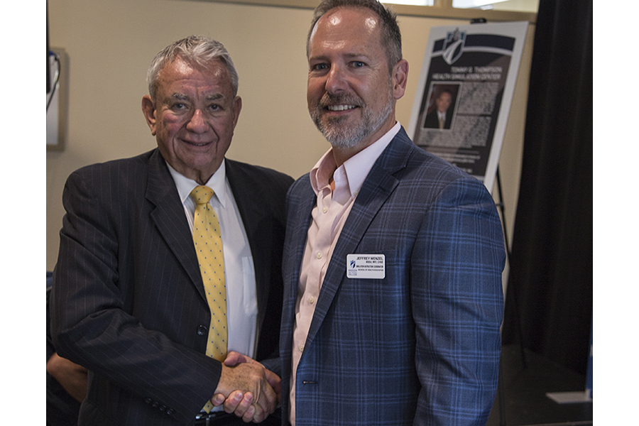 Former Gov. Tommy Thompson, left, poses for a photograph with Simulation Instruction Coordinator Jeffrey Wenzel.