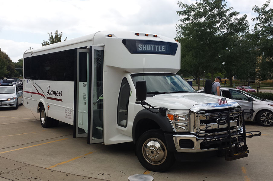 A campus-to-campus shuttle waits for students outside the Truax Campus Gateway.