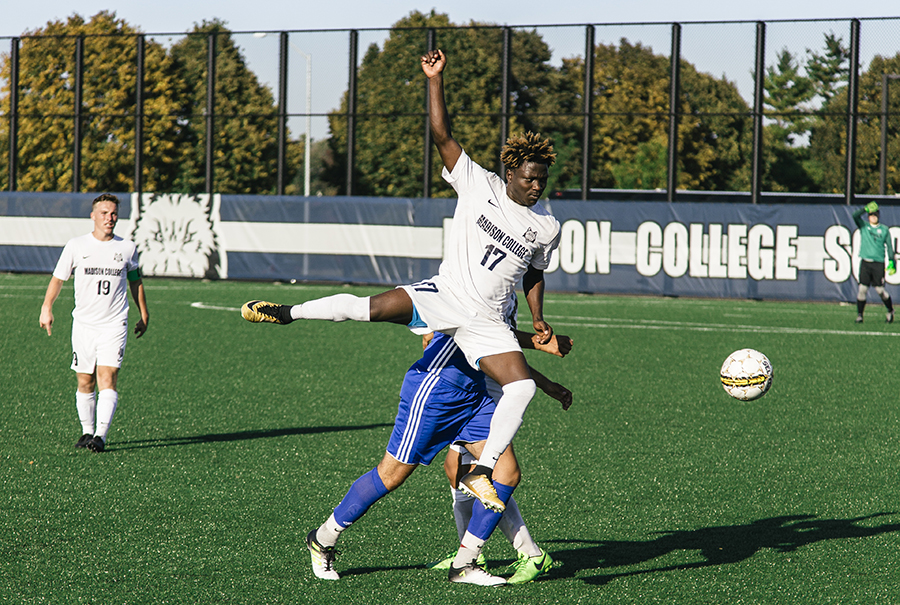 Madison College midfielder Vital Nizigiymana (17) goes airborne.