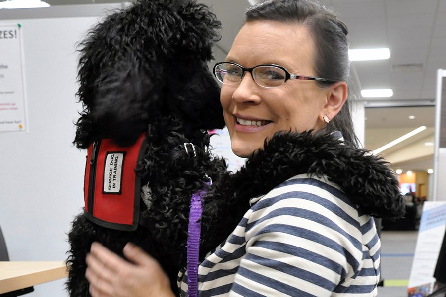 Juliet gives her trainer, Heather Morgan, a hug during a recent visit to the Madison College Student Life Center.