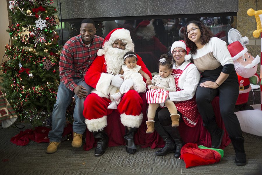 Louis Bentley, left, and his son, Luca Bently, visit with Santa and Mrs. Claus at the Snacks with Santa event in the Truax Campus Gateway on Dec. 2. Louis Bentley is a 2008 graudation of the college’s EMT program.