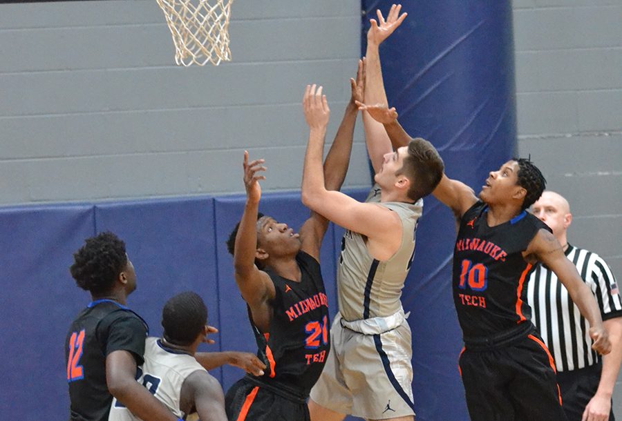 Madison College’s Alex Easterday shoots over a Milwaukee Area Technical College defender during the WolfPack’s 93-81 victory on Jan. 10.