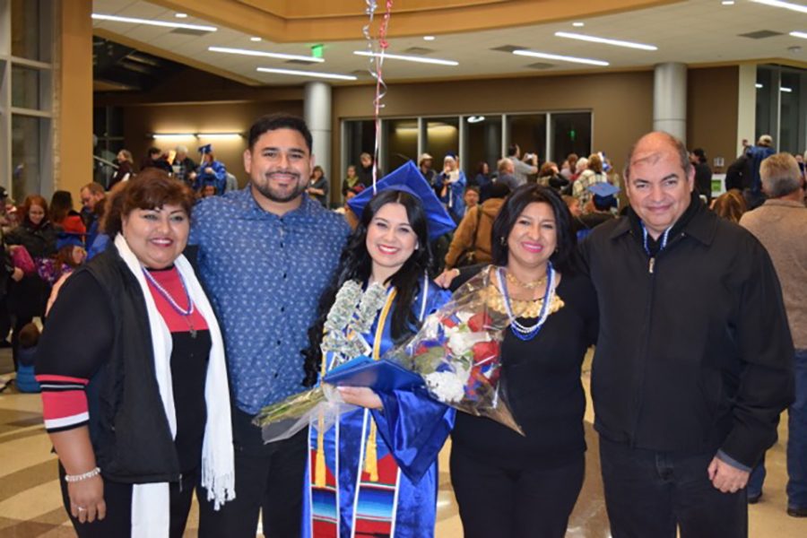 Vianey+Hernandez%2C+center%2C+poses+with+her+family+at+graduation.+Hernandez+was+the+student+speaker+at+the+mid-year+graduation+ceremony.