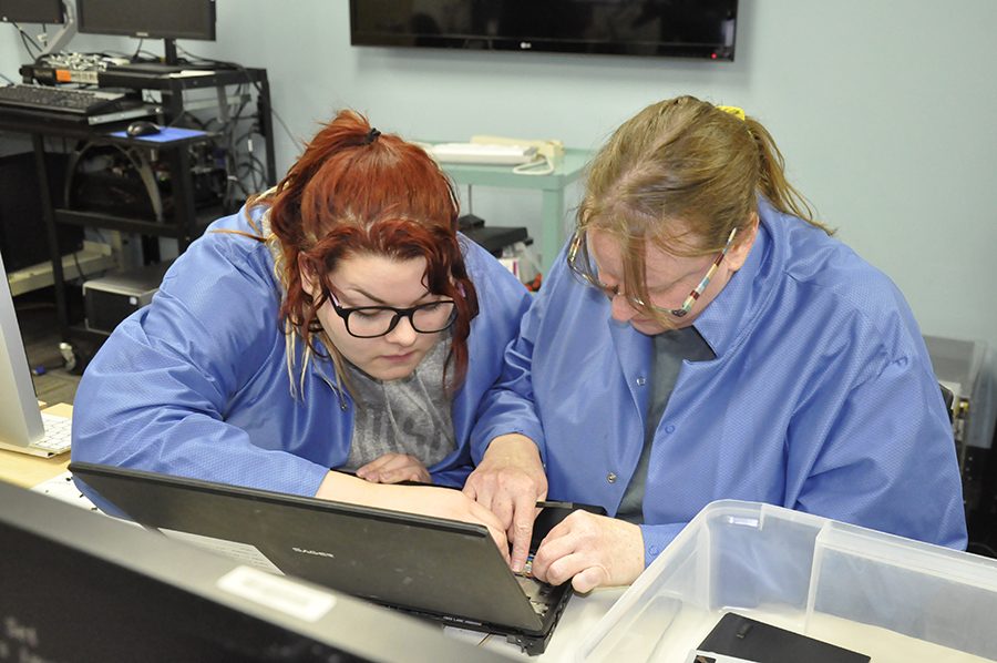 Members of the Madison College WolfPack Techies work to troubleshoot potential computer problems.