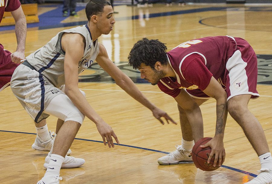 Madison College men’s basketball player Marcus Riser defends a Triton College opponent during a recent game.