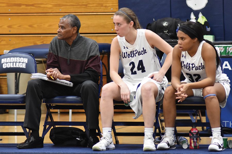 Madison College’s assistant women’s basketball coach Mike Mayfield, left, watches a recent game with players Megan Corcoran, center, and Tierra Sackett.