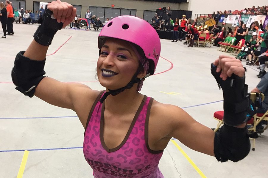 Madison College student Angelique Camp competes with the Vaudeville Vixens roller derby team.