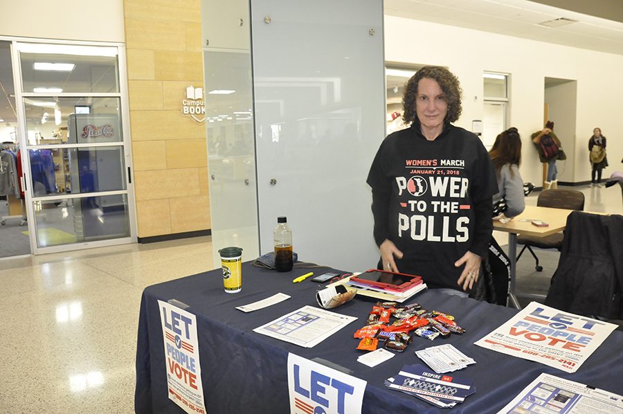 A League of Women Voters volunteer helps students get registered to vote during a visit to the Truax Campus in February.