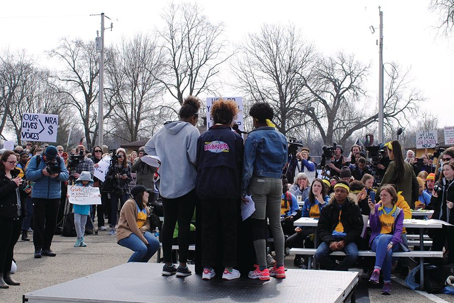 Selame Caldart, Alemitu Caldart and Hiwot Schutz perform a spoken word poem about gun violence at the rally in Janesville after the 50 Miles More march from Madison.