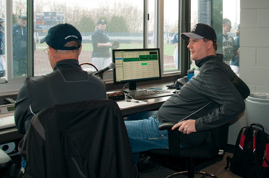 Adam Eichstedt, right, takes a break while announcing a recent Madison College softball game. Eichstedt announces games for Madison College, Edgewood College and UW-Madison men’s hockey and women’s basketball.