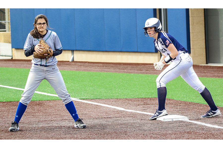 Madison College’s Ashley Kniesel eyes the pitcher from first base during her team’s game against Bryant and Stratton College.