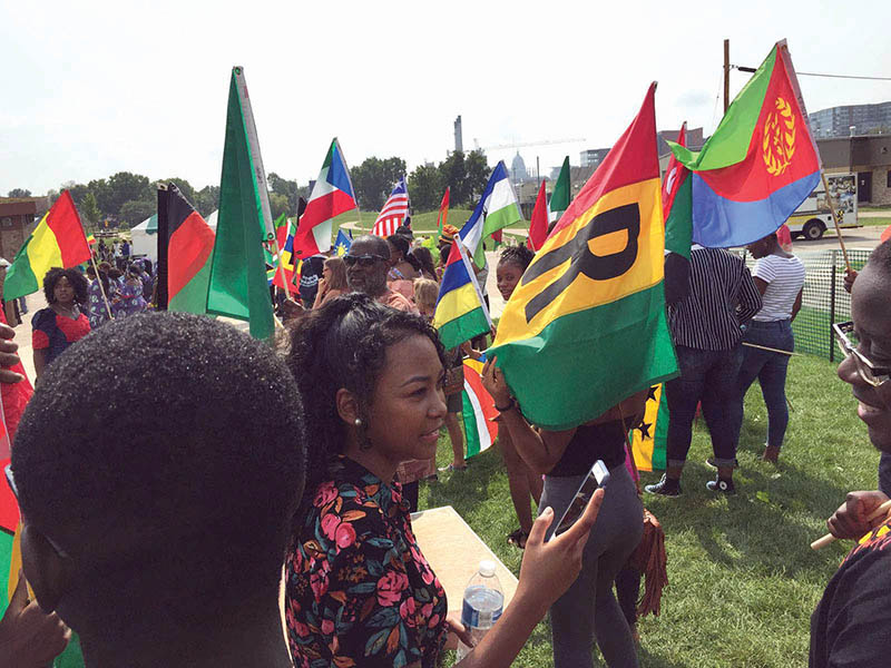 Paraders wave flags with pride at Africa Fest