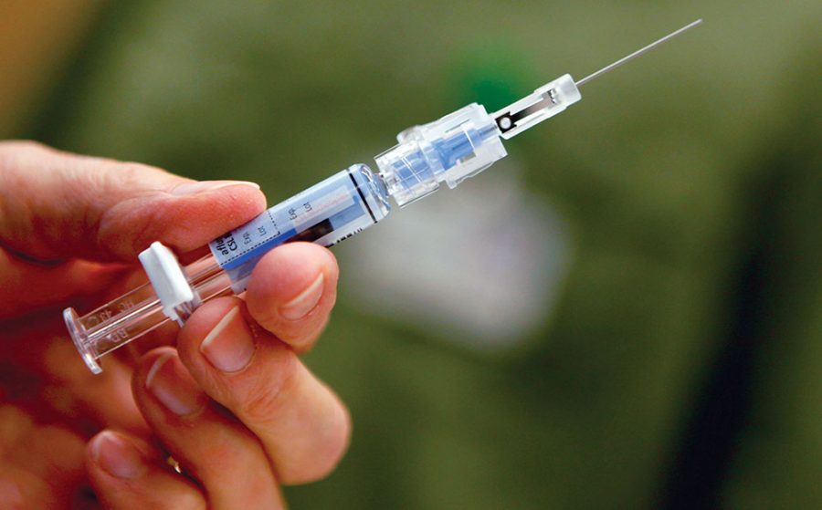 Image of a hand holding a syringe